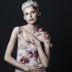 Beauty portrait of a woman covered in flowers